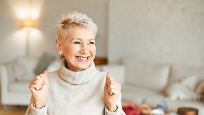 brightly-health-coaching-indoor-shot-fashionable-overjoyed-mature-female-turtleneck-sweater-enjoying-positive-news-having-ecstatic-facial-expression-laughing-clenching-fists-success-achievements-concept
