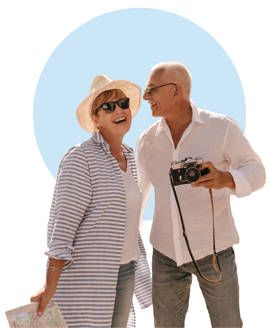 Age-Brightly-positive-man-with-grey-hair-light-shirt-jeans-with-camera-laughing-with-blonde-lady-hat-sunglasses-striped-blue-shirt-park-cutout-circle-1