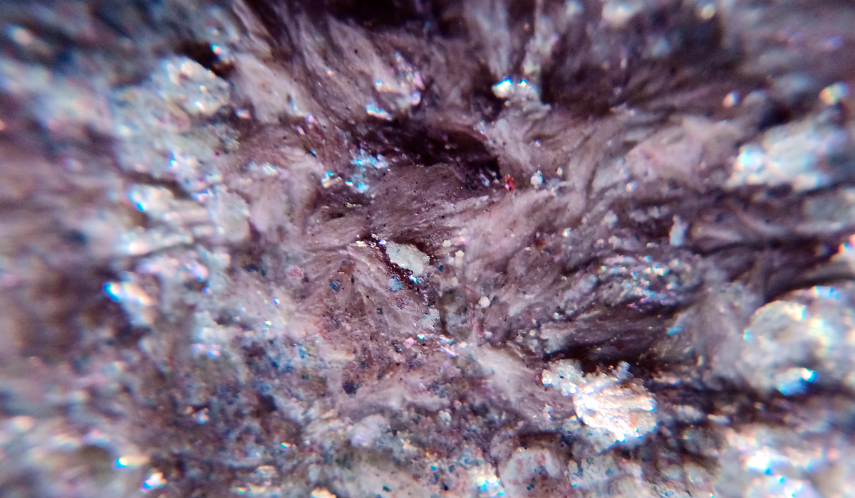 Brightly-Biomarkers-black-rock-with-blue-red-speck-center