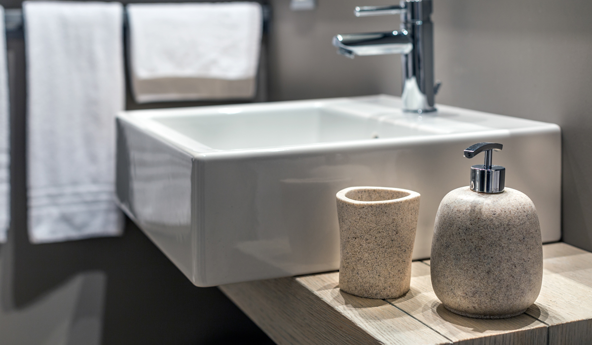 Brightly-Biomarkers-shallow-shot-modern-sink-beside-bottle-bathroom