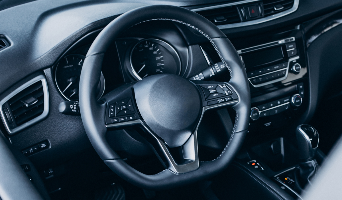 Brightly-Biomarkers-steering-wheel-inside-new-car-close-up