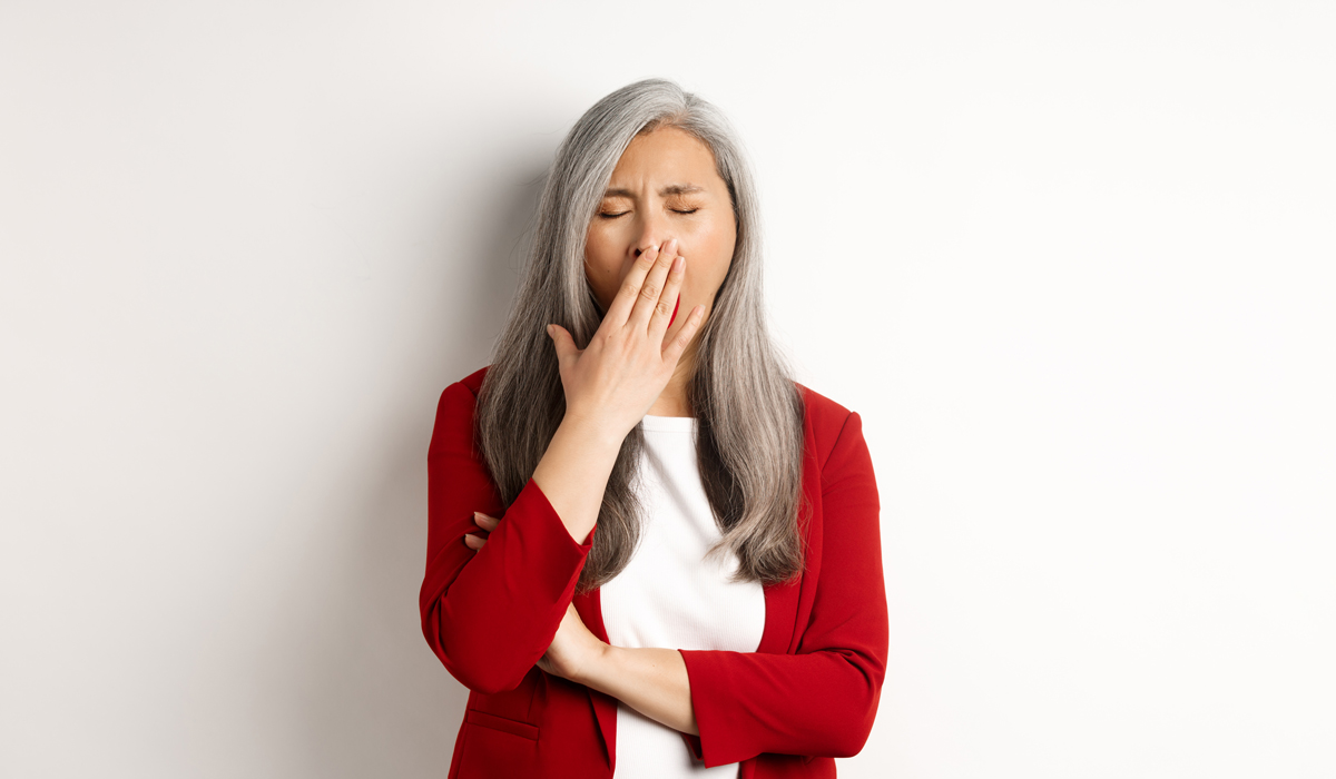Brightly-Biomarkers-tired-bored-asian-businesswoman-yawning-covering-mouth-with-hand-standing-exhausted-white-ba